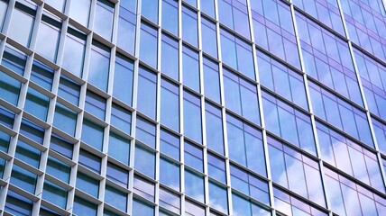 Glass clad facade of a modern building covered in reflective plate glass.