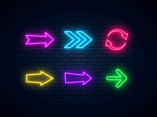 Neon arrow signs set. Bright arrow pointer symbols on brick wall background. Collection of colorful neon arrows, web icons. Banner design, bright advertising signboard elements. Vector illustration.