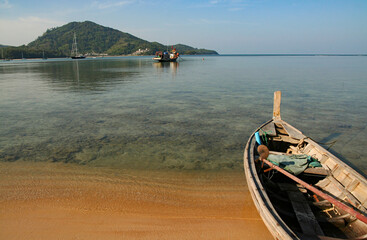 A local fishing boat on the beach., Traditional fishing boats on the coast at dawn To wait for the night fishing.