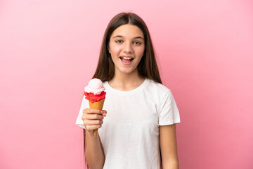 Little girl with a cornet ice cream over isolated pink background with surprise facial expression