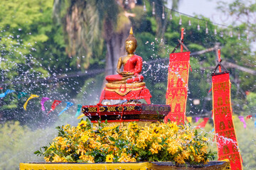 The tradition of bathing the Buddha on an annual basis Chiang mai Songkran festival, Thailand.
