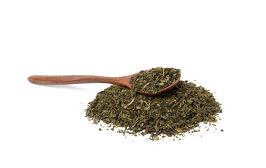 pile of dry green tea and brown wooden spoon