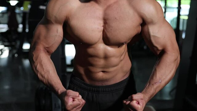 Footage of Naked Bodybuilder Flexing His Muscle