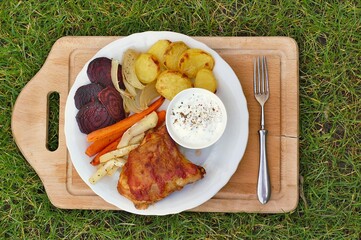 Roasted chicken leg with grilled vegetables potato, carrot, beetroot, onion