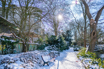 snowy winter walkway at rampart and small lake in bremen behind art gallery in the sun