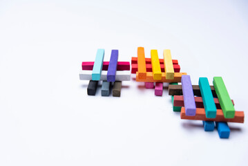 GROUPS OF COLORED CHALKS IN PILES ON A WHITE BACKGROUND