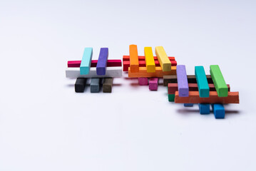 GROUPS OF COLORED CHALKS IN PILES ON A WHITE BACKGROUND