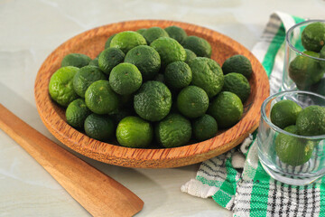 kaffir lime on a coconut wood plate