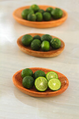 kaffir lime on a coconut wood plate