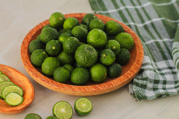 kaffir lime on a coconut wood plate