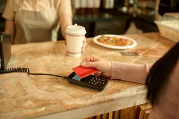  customer paying with credit card in cafe. 