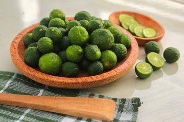 kaffir lime on a coconut wood plate