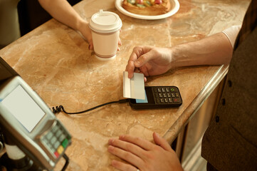  customer paying with credit card in cafe. 