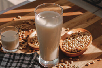 soy milk and soybeans on a wooden table