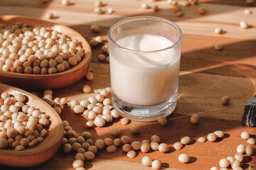 soy milk and soybeans on a wooden table