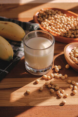 soy milk and soybeans on a wooden table
