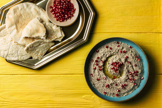 Baba ganoush or mutabal, Middle Eastern eggplant dip sauce garnished with pomegranate seeds, with various ingredients