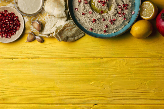 Baba ganoush or mutabal, Middle Eastern eggplant dip sauce garnished with pomegranate seeds, with various ingredients