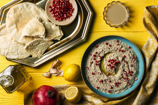 Baba ganoush or mutabal, Middle Eastern eggplant dip sauce garnished with pomegranate seeds, with various ingredients