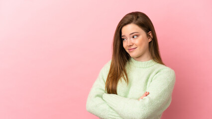 Fototapeta premium Teenager girl over isolated pink background making doubts gesture while lifting the shoulders