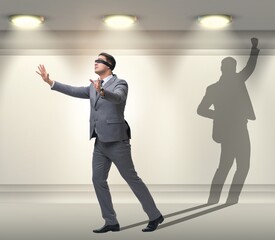 Businessman and his shadow in business concept