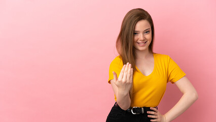 Teenager girl over isolated pink background inviting to come with hand. Happy that you came