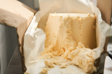 Fresh tasty butter standing at the box at the kitchen table