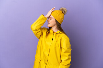 Teenager girl wearing a rainproof coat over isolated purple background has realized something and intending the solution