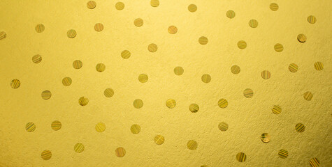 Gold sparkling confetti on a gold background. Flat styling style