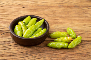 Green cheiro (scent/smell) pepper on a bowl over wooden table