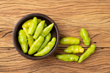 Green cheiro (scent/smell) pepper on a bowl over wooden table