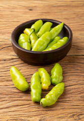 Green cheiro (scent/smell) pepper on a bowl over wooden table