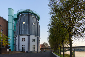 Outdoor scenery view on promenade riverside of Meuse river and Bonnefantenmuseum during sunset time...