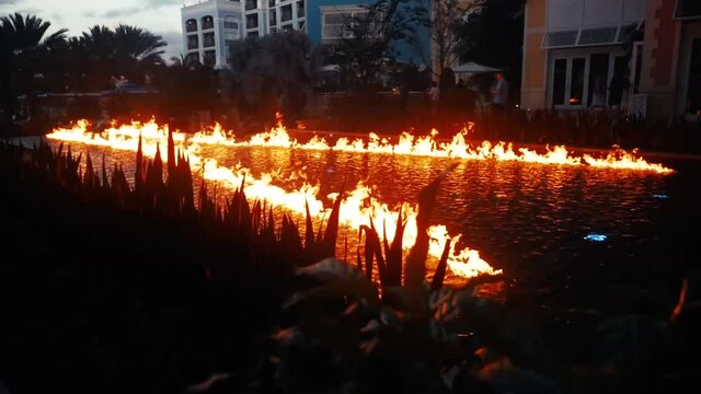 An arrow of fire burns atop a pool of water.