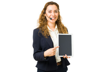 Attractive woman pointing to a blank screen of a tablet