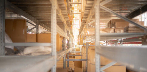 The storage warehouse of the cardboard boxes put on the stainless steel shelves,  industry warehouse concept.