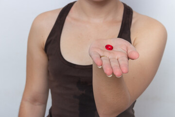Brown tank top woman on white background with hair tied with vitamin