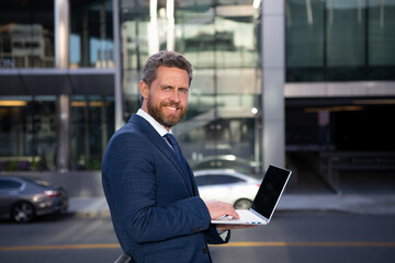 Fototapeta premium Business man portrait. Smiling american businessman CEO standing outside office workplace.