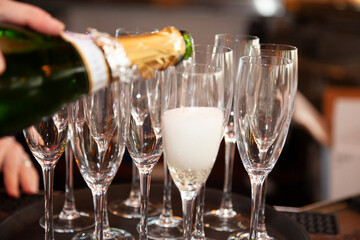 pouring champagne into champagne glasses