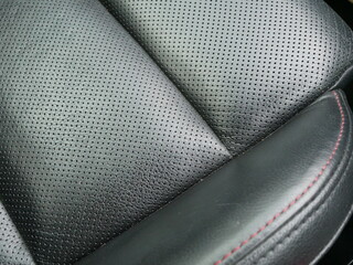 closeup of black leather car seat texture background.