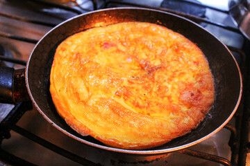 an omelet in preparation in the pan