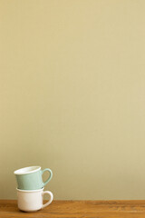 Stack of mug cup on wooden table. khaki beige background