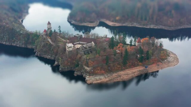 Aerial view of the Hrad Zvikov - a beautiful medieval castle standing on the peninsula on one of the turns of the Vltava river. Overlooking the wide river and the forest. A tilt-shift video.