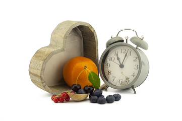 Culinary still life with clock, spoons and berries