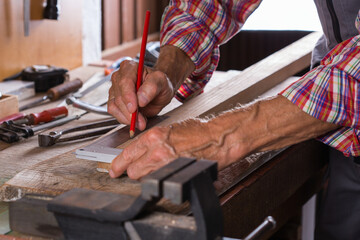 Carpenter working on the work bench, joinery tools and woodwork