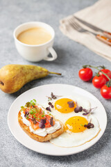 Eggs with microgreens and sandwich with cheese and salmon. Healthy breakfast