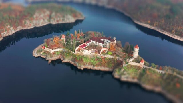 Hrad Zvikov - a beautiful medieval castle standing on the rocky peninsula on one of the turns of the Vltava river. Overlooking the wide river and the forest. A narrow road snaking through the woods.