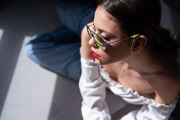 Fashion sunglasses. Young woman in glasses. Sensual model girl posing.