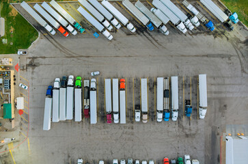 Aerial top view semi truck with cargo trailer car parking of truck dock