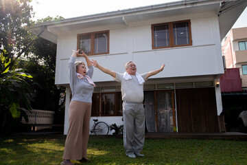 Happy Asian family exercising together at home. Healthy senior couple do outdoor workout exercise yoga tai chi together in the morning. Retirement elderly man and woman enjoy leisure activity at home